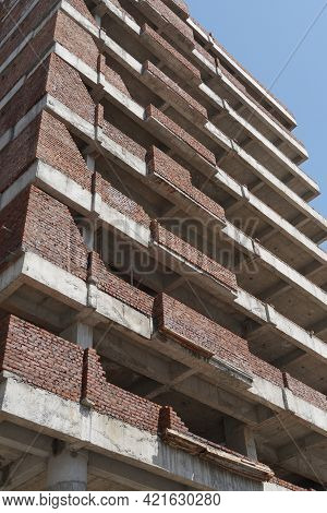 Building Under Construction Against Blue Sky. General View Of The Construction Of A New Residential 