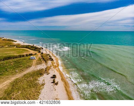 Aerial View. Coastal Landscape With Caravan Wild Camping On Beach Sea Shore. Mediterranean Coast Of 