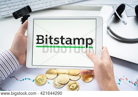 Russia Moscow 05.05.2021.businessman Holding Tablet With Logo Of Cryptocurrency Stock Exchange Bitst