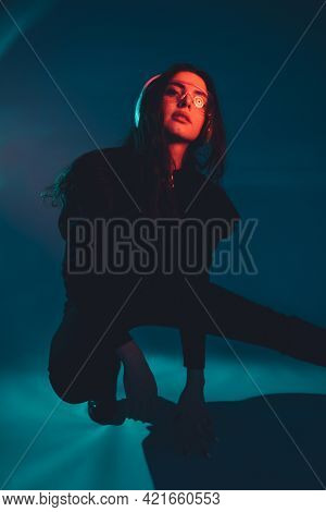 Cyberpunk Culture. Urban Life. Futuristic Technology. Confident Arrogant Red Neon Light Woman In Bla