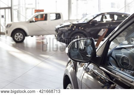 New Modern Unknown Cars At Dealer Showroom. Car Auto Dealership. Prestigious Vehicles. Themed Blur B