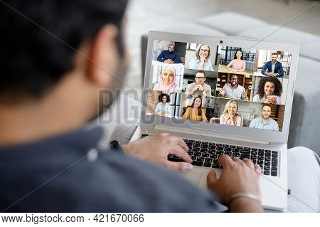 Young Businessman Using Laptop App For Video Connect With Colleagues, Takes Part In Video Conference