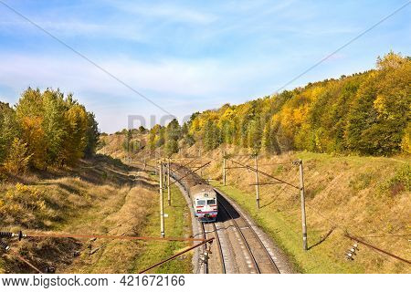 Electric Mainline Railroad In Autumn Yellow Forest