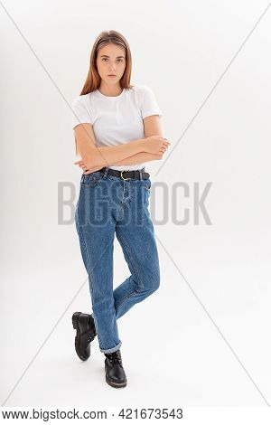 Portrait Of Young Attractive Caucasian Woman With Long Hair In T-shirt And Blue Jeans Isolated On Wh