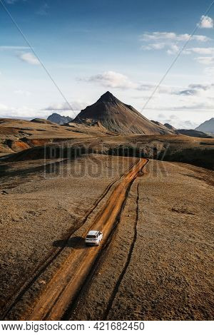 2019, Iceland, White Landrover driving on a dusty sand road
