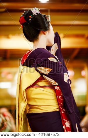 Maiko Apprentice Showing Japanese Traditional Dance. Maiko Is An Apprentice Geisha. Maikos Performin