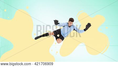Composition of football goalkeeper over yellow splodges and blue background. sports event and competition concept digitally generated image.