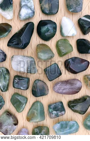 Moss Agate Rare Jewel Stones Texture On Light Varnished Wood Background
