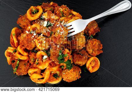 Beef And Pork Meatballs Al Forno With Trulli Pasta In Tomato Sauce Meal On A Slate Stone Background