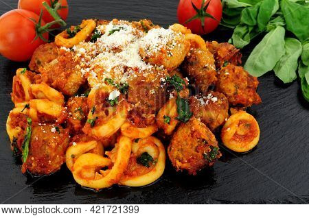 Beef And Pork Meatballs Al Forno With Trulli Pasta In Tomato Sauce Meal On A Slate Stone Background