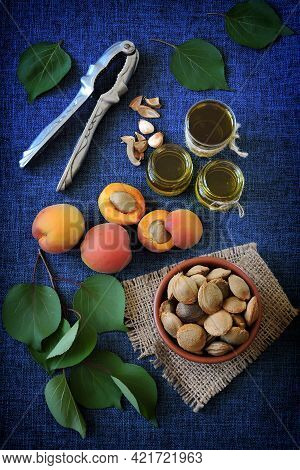 Jars Of Apricot Kernel Oil. Apricots, Leaves, Seeds.