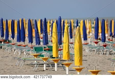 Beach With Closed Umbrellas With No One Above Him Lie Down Because Of The Lockdown In The Resort By 