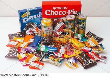 Tambov, Russian Federation - October 30, 2020 A Lot Of Sweet Snacks And Drink Jars On White Table. O