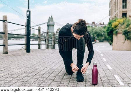 Beautiful Young Slim Woman Is Jogging Along The Embankment Of The River In London. Stay Healthy, Do 