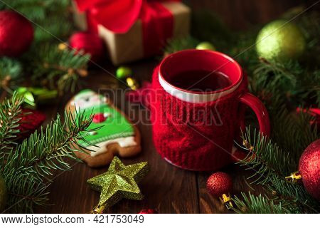 Hot Christmas Tea With Gingerbread Cookie On Wooden Table. Top View. New Year And Christmas Celebrat
