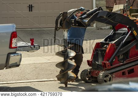 Connecting Hydraulics To A Large Drill For Drilling Holes In The Ground For Planting Trees