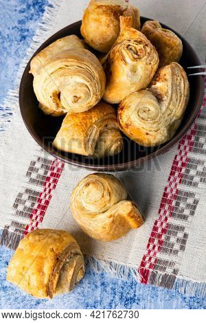Fresh homemade puff pastry rolls baked with cinnamon. Top view. 