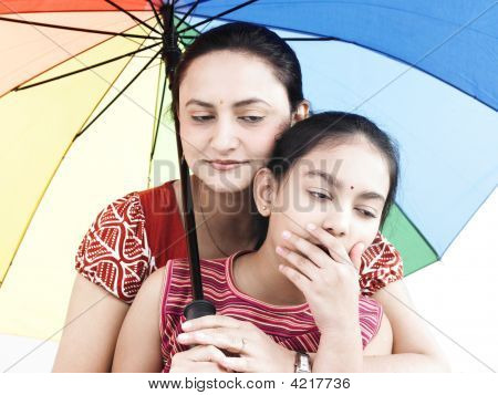 Mother And Daughter With One With Rainbow Umbrella