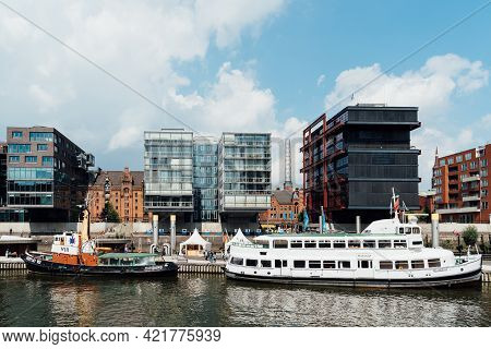 Hamburg, Germany - August 7, 2019: Cityscape Of Sandtorhafen Canal With Ships Moored On The Harbour 