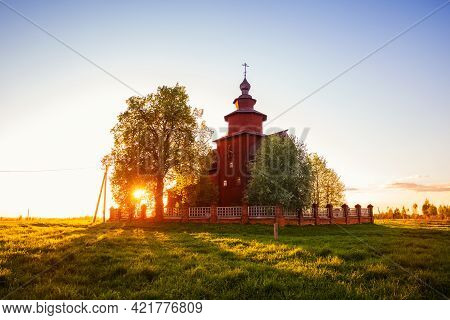 Old Rural Wooden Church Of St. John The Theologian On The Ishnya River. Spring Sunset Landscape. Yar