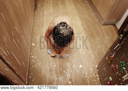 Child Cleaning Up After A Flour Fight. Punishment For Kids Concept.