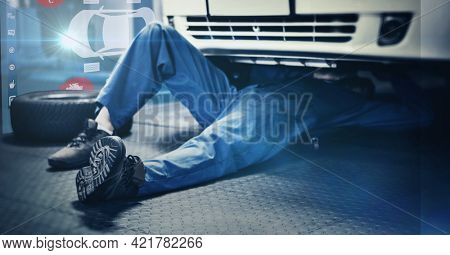 Composition of interactive screen with digital car drawing over car mechanic lying under car. car mechanic garage and technology concept digitally generated image