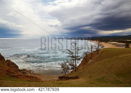 Lake Baikal On A Cloudy Spring Day. Stormy Sky, Sarai Bay During The Melting Of The Ice. Olkhon Isla