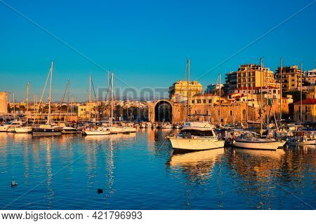 Venetian Fort castle in Heraklion and moored fishing boats, Crete Island, Greece on sunset