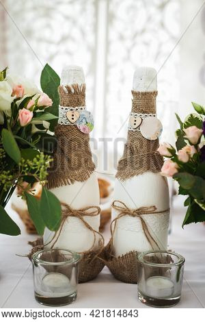 Decorated Champagne Bottles, Glasses And Flowers. Wedding Theme
