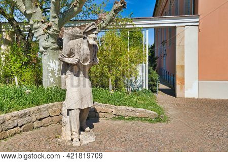 Bad Dürkheim, Germany - April 2021: Sculpture Of A Winegrower With Basket Full Of Grapes By Werner B