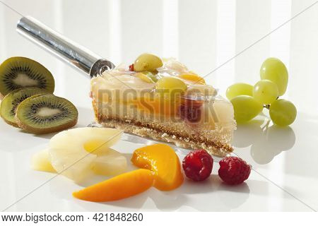 Slice Of Fruit Cake On Cake Server With Various Fruit, Close Up