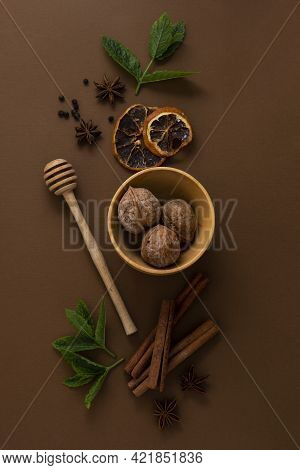 Fflat Lay Condiments And Spices, Honey Spoon, Anise Star, Cinnamon Sticks, Mint Leaves, Brown Backgr