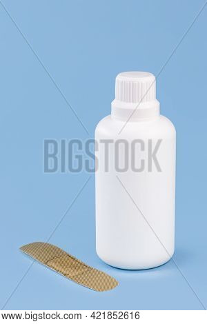 Hydrogen Perhydrogen Peroxide, In White Plastic Packaging, With Band Aid And Isolated Blue Backgroun