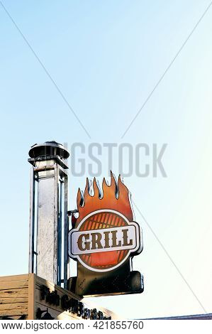Nameplate Affixed To The Chimney On The Roof Of The Building. Grill Lettering. Close-up