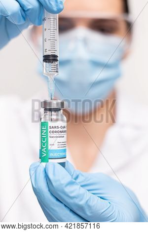 Sars - Cov2 Vaccination Concept. Close Up Covid-19 Vaccine Dose. A Doctor Or Nurse In A Laboratory H