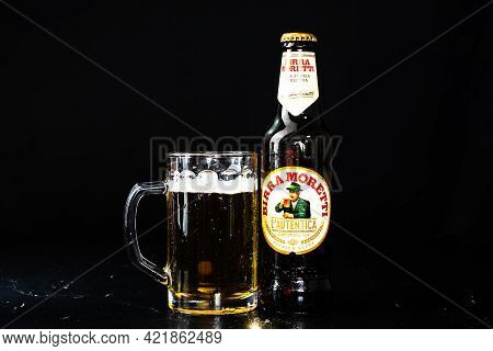 Can Of Birra Morreti Beer And Beer Glass On Dark Background. Illustrative Editorial Photo Shot In Bu