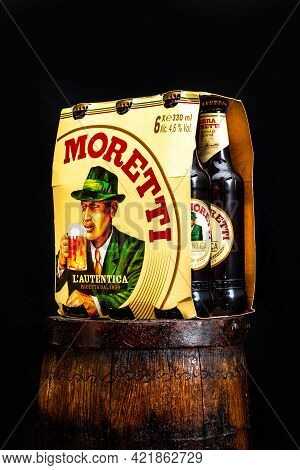 6 Pack Of Birra Moretti Beer On Wooden Barrel With Dark Background. Illustrative Editorial Photo Buc