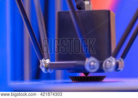Print Head Of 3d Printer Machine Printing Plastic Model Against Blue Background At Modern Scifi Tech