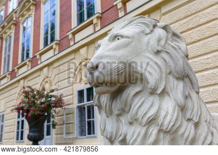 Lancut, Poland - August 26, 2020: Statue Of Stone Lion In Front Of 16th Century Baroque Lancut Castl