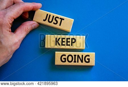 Just Keep Going Symbol. Wooden Blocks With Words 'just Keep Going'. Beautiful Blue Background, Busin