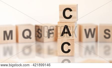 Wooden Cubes With Letters Cac Arranged In A Vertical Pyramid, On The Light Background, Reflection Su