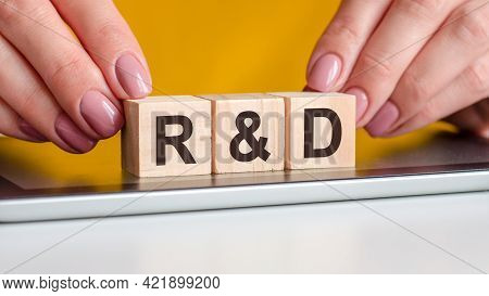 The Word R And D Is Written On Wooden Cubes Standing On A Notepad. Selective Focus. Business, Educat