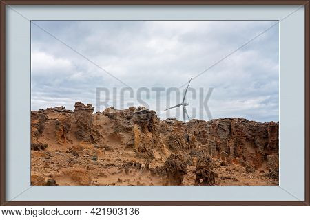 Modern Wind Turbines In A Petrified Limestone Forest In A Photo Frame