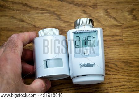 Paris, France - Apr 21, 2021: Pov Male Hand Holding Netatmo By Stark Intelligent Radiator Thermostat