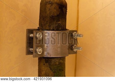 The Four-screw M10 Stainless Steel Pipe Clamp Attached To A Rusty Metal Pipe. Plumbing Repair