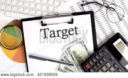 Text Target On Office Desk Table With Keyboard, Dollars,calculator ,supplies,analysis Chart On The W