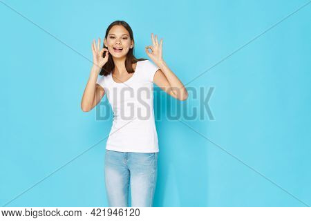 Woman In White T-shirt And Jeans Fun Emotions Tinplate Hands Blue Background