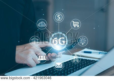 Young Man Hand Holding A Phone With A 6g Hologram. 6g Network Wireless Systems.the Concept Of 6g Net