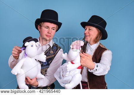 Actors With Moomin Troll Dolls On A Blue Background - Moscow, Russia, April 28, 2021