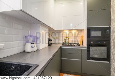 Well designed small dark grey modern kitchen interior